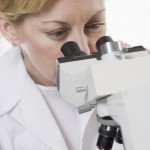 Lab Technician Using Microscope