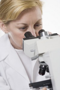 Doctor looking through a microscope.