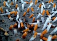 image of used cigarettes in sand.