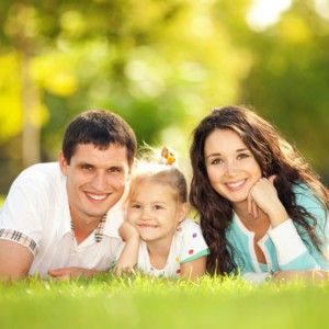 Happy mother, father and daughter in the park