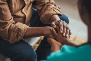 Two People of Color Holding Hands